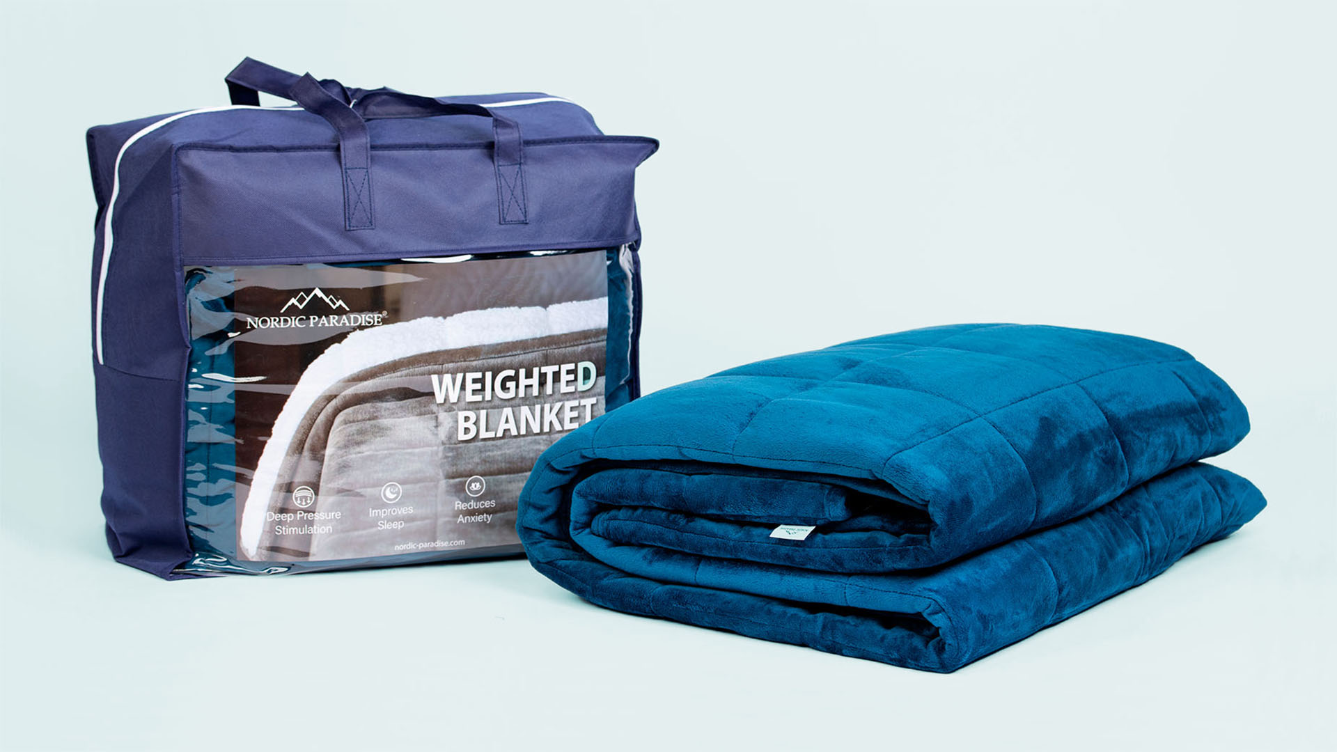 Folded blue weighted blanket and a packaging on light blue background