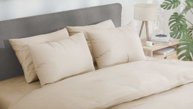 Bed with beige sateen bedsheets and down pillows and duvets