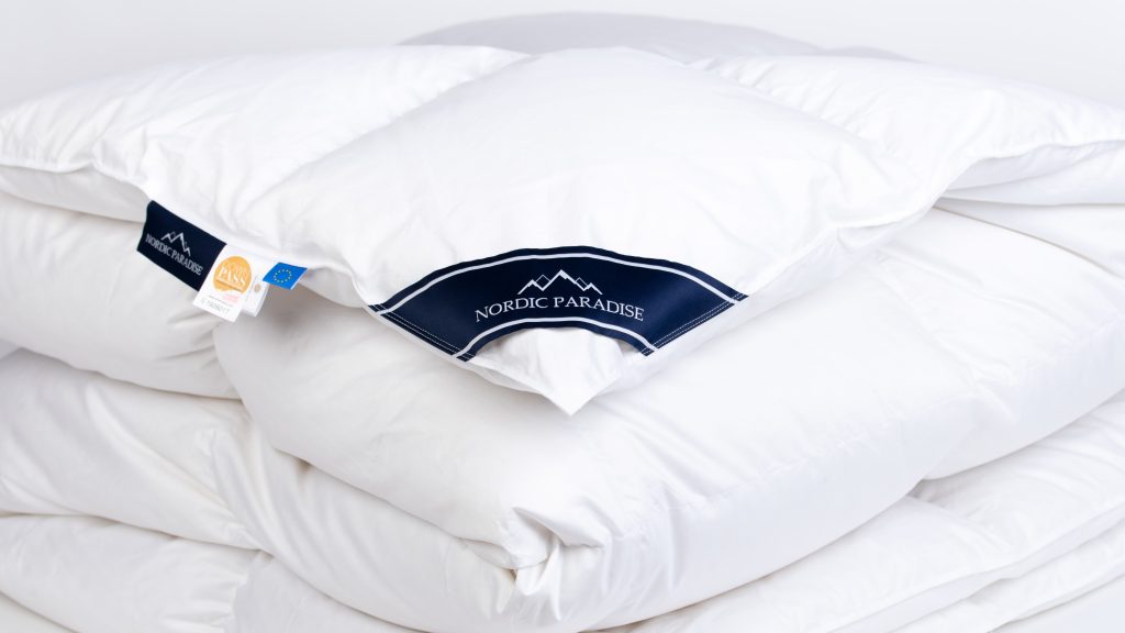 zoom on folded down duvet with Nordic Paradise logo
